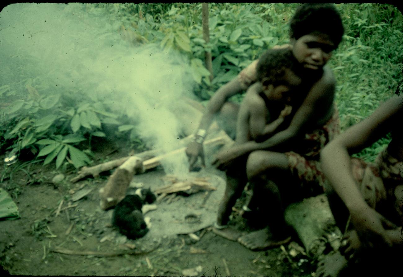 BD/144/280 - 
Papoea-vrouwem bij vuurtje, waarvan een met kind
