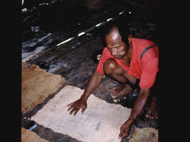 BD/27/9 - 
Man with spread out bark cloth
