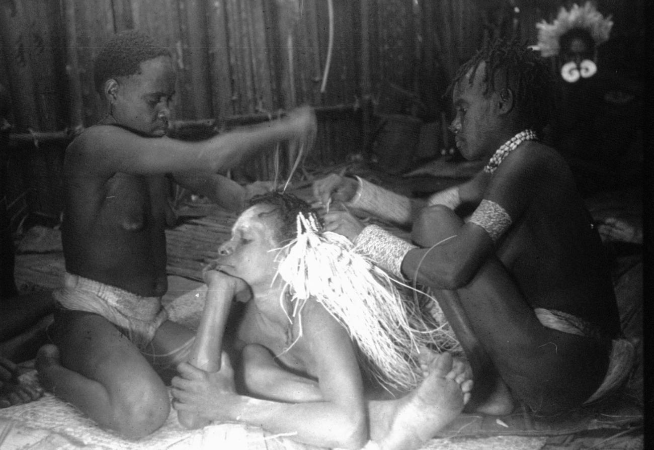 BD/216/149 - 
Vrouw wordt voor ritueel getooid met palmvezels voor adoptie door andere stam
