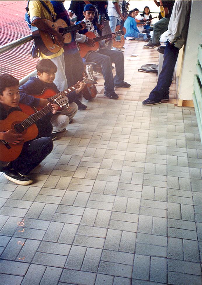 BD/269/108 - 
Leerlingen spelen gitaar op een veranda in Tembagapura
