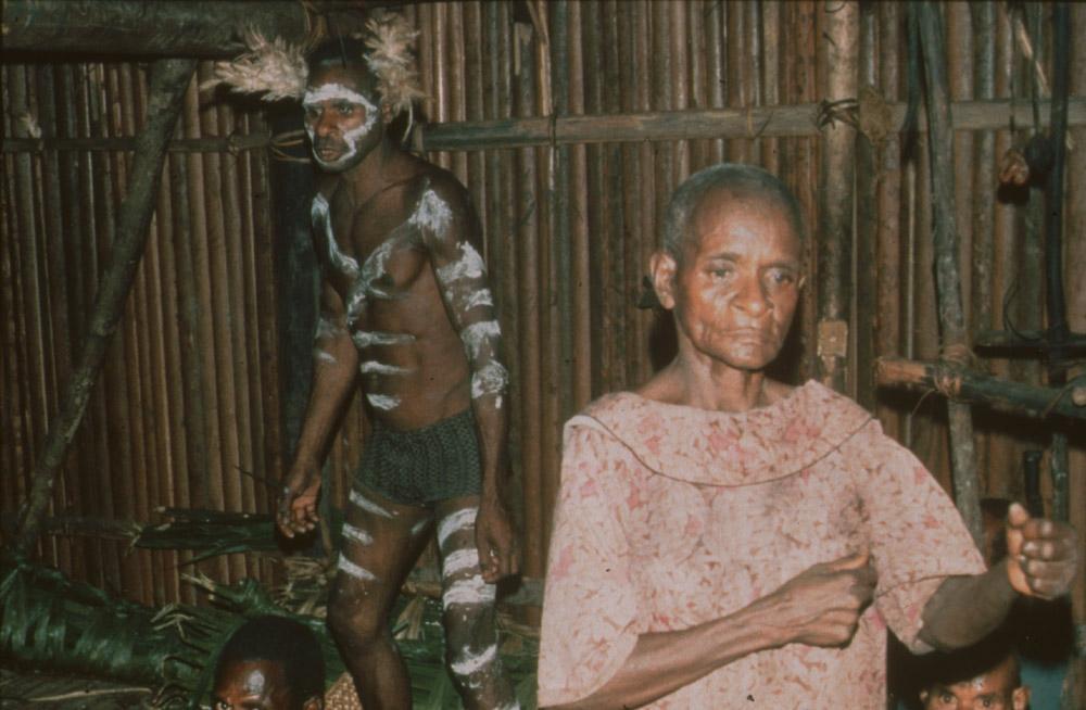 BD/30/87 - 
Asmat woman and white painted man inside bamboo house
