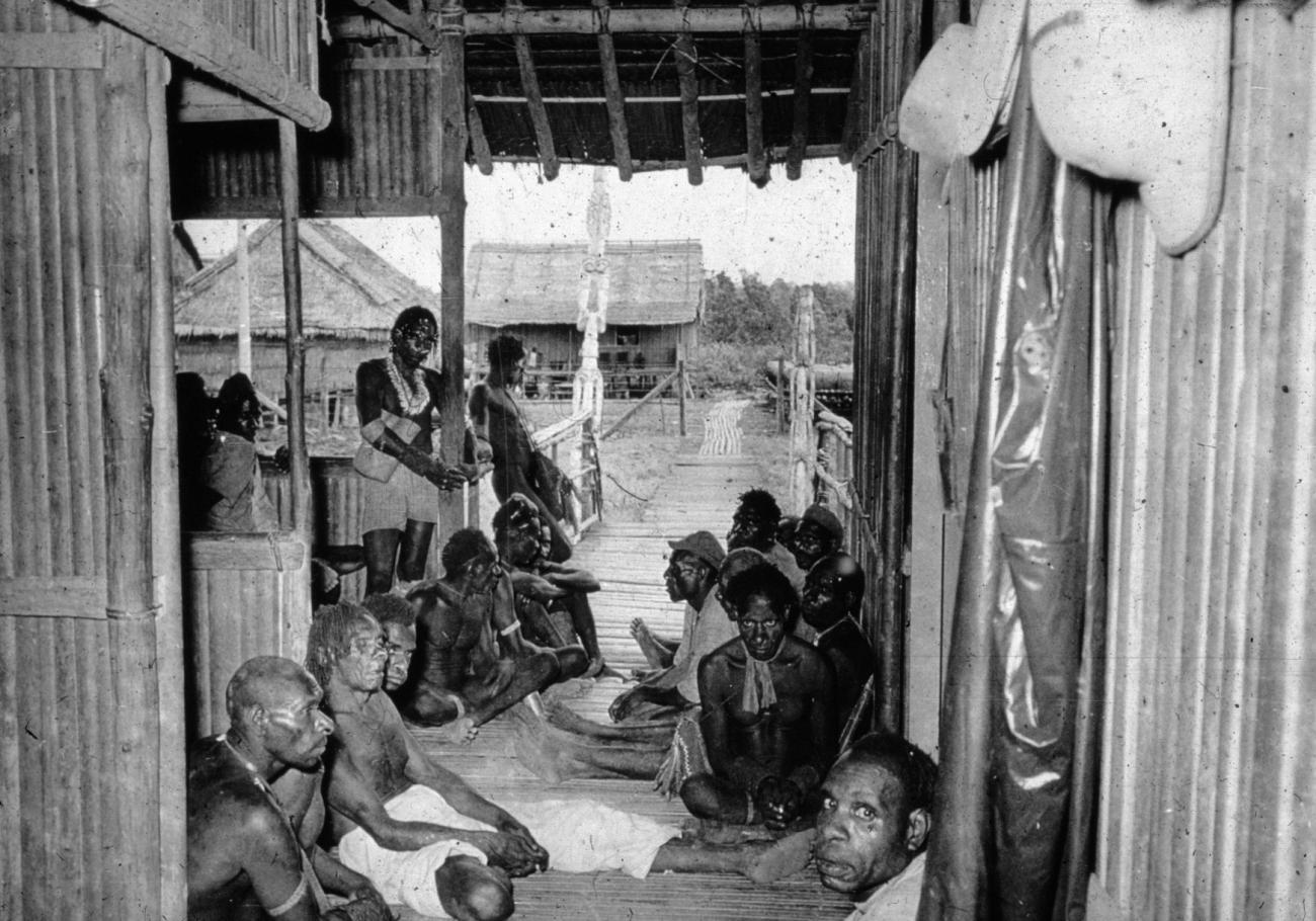 BD/66/174 - 
Vergadering van ouderen in hut in een Asmatdorp

