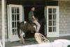 BD/288/164 Henk van Baaren op een veranda op een pony