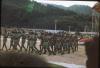 BD/171/150 Papua vrijwilligerskorps marcherend met geweer tijdens de parade op koninginnendag