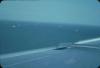 BD/171/65 Luchtfoto vanuit een vliegtuig met schepen op zee