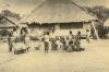 BD/269/1150 Westerling en groep Papoea's met (handels)waar voor de pastorie in Arso